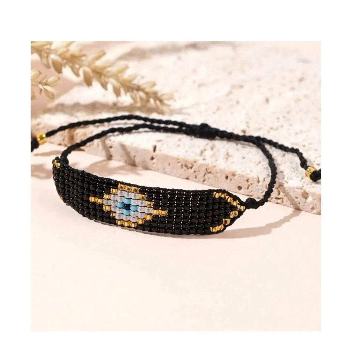 Black Miyuki bead bracelet with evil eye design and adjustable braided cord