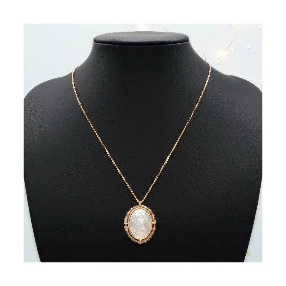 Religious Fatima pendant featuring mother of pearl and tan crystal border
