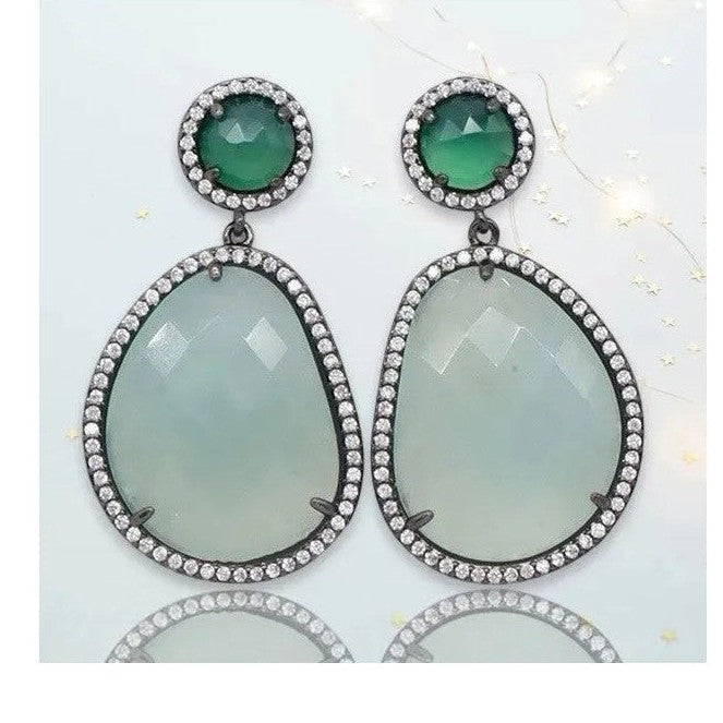 Gunmetal pave drop earrings featuring emerald green faceted stones