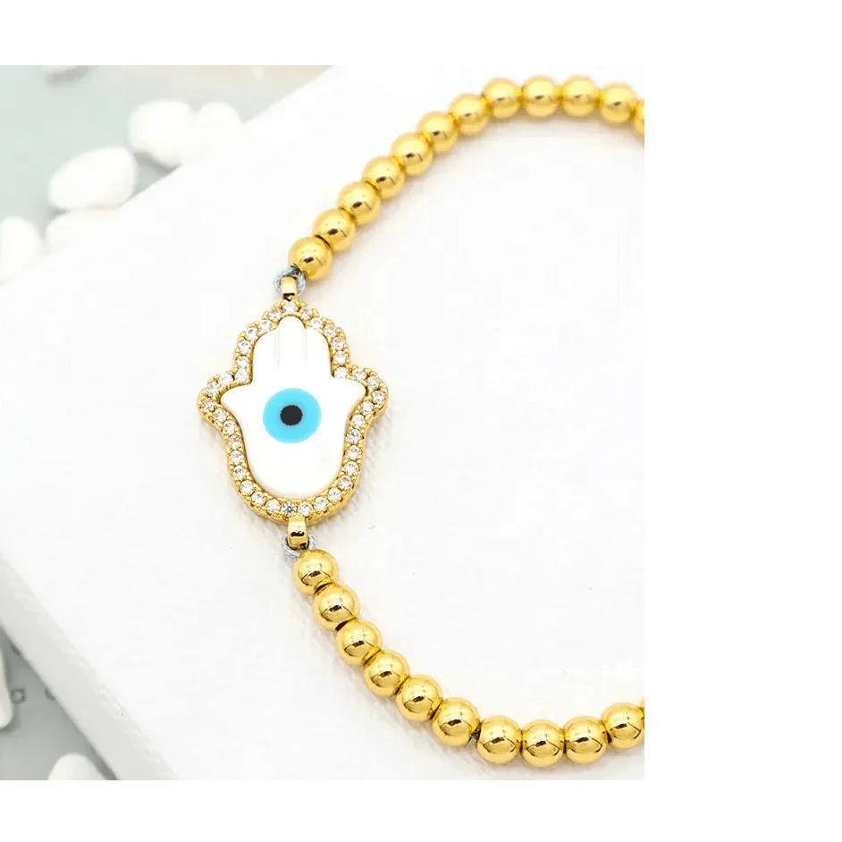 Gold plated Hamsa hand bracelet with white enamel and evil eye center