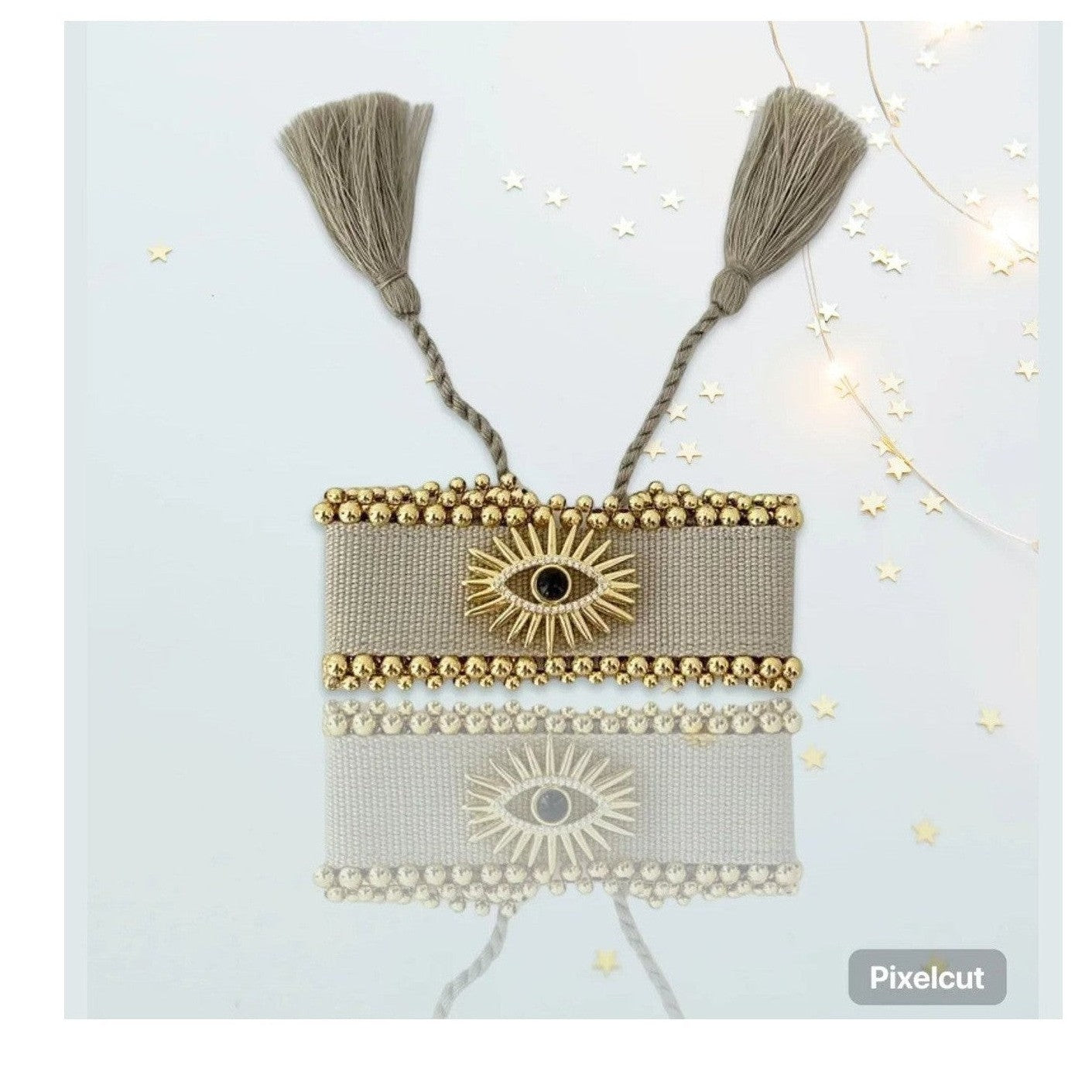 Taupe Stella Bohemian Bracelet with gold evil eye charm and tassels