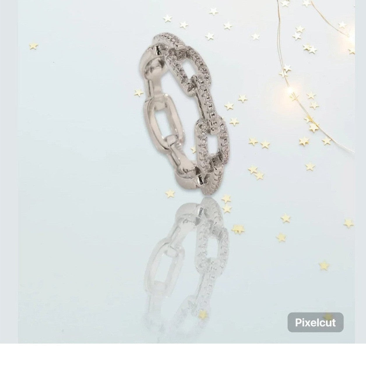 Silver-toned chain-link ring paved with clear stones and smooth links