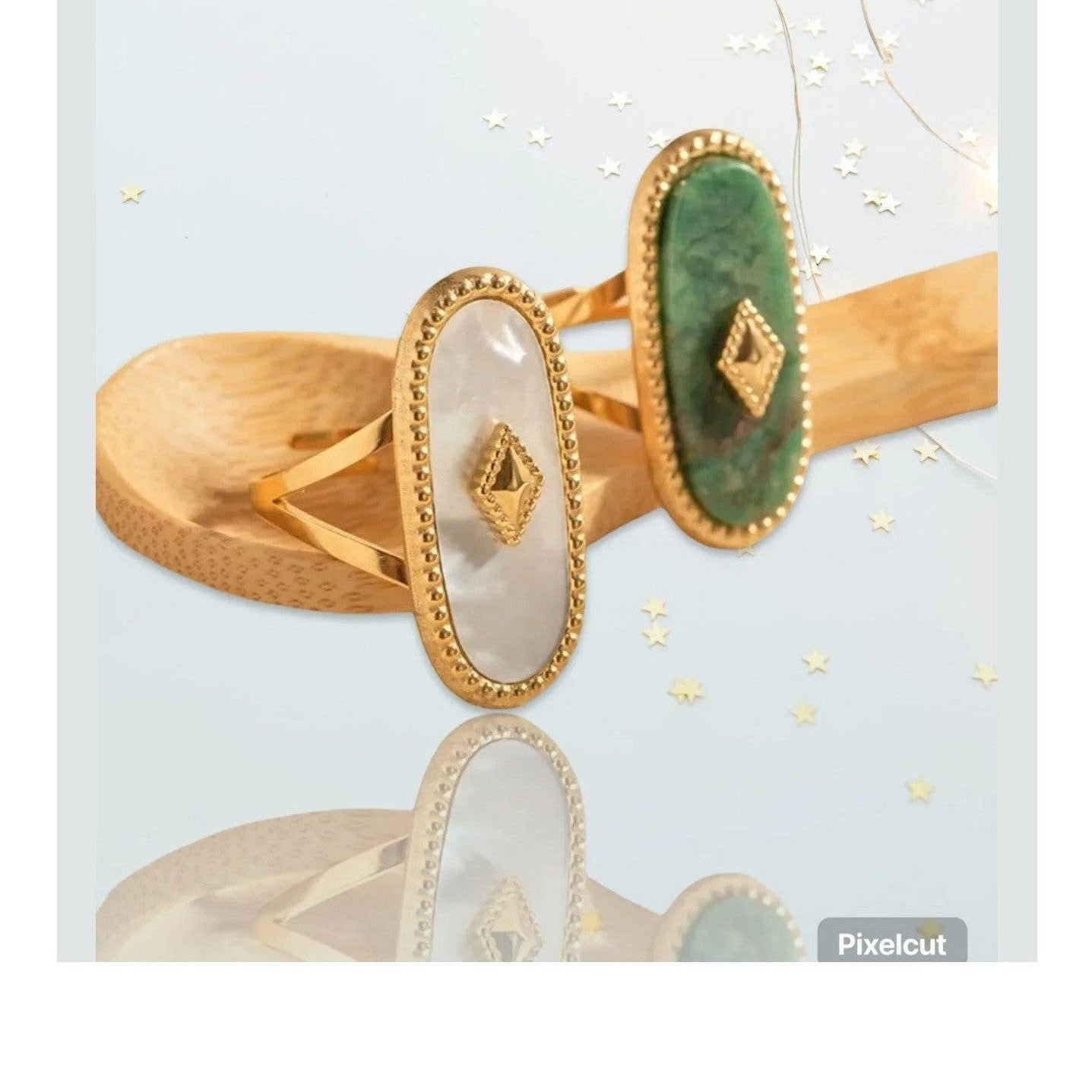 Pair of oval mother-of-pearl and green stone rings with gold borders