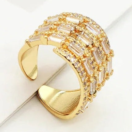 Wide gold cuff ring with baguette clear stones