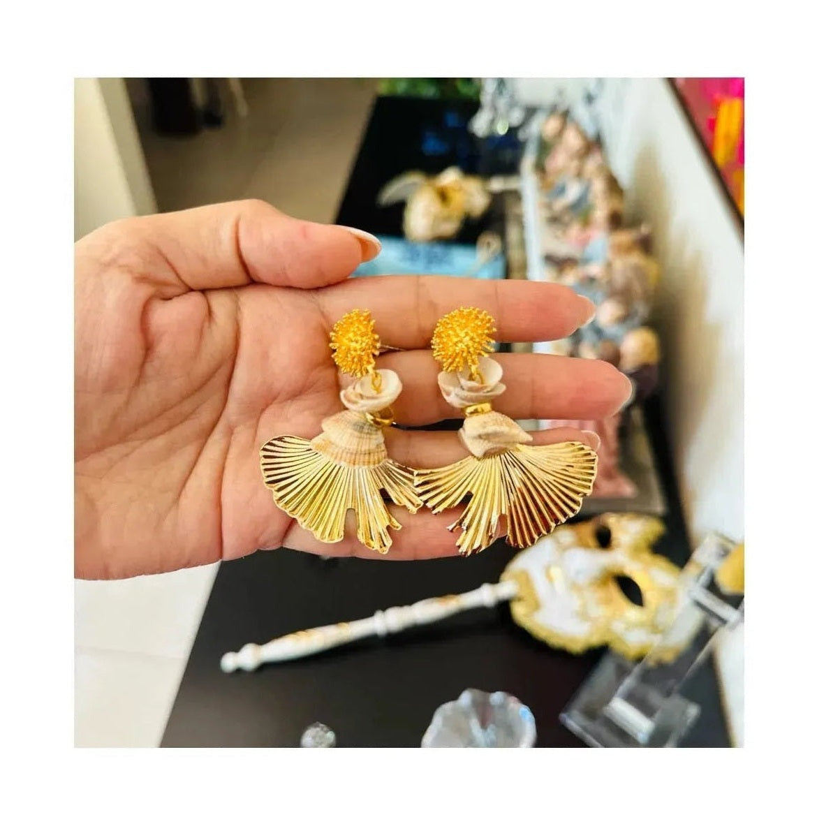 Zoya gold plated dangling earrings with shell accents and pleated fan drops